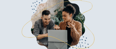 A man and a woman working on a computer.