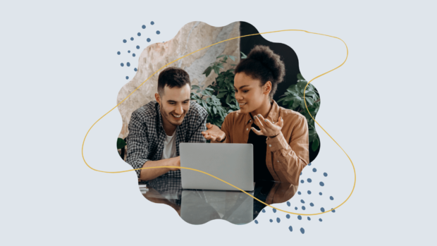A man and a woman working on a computer.